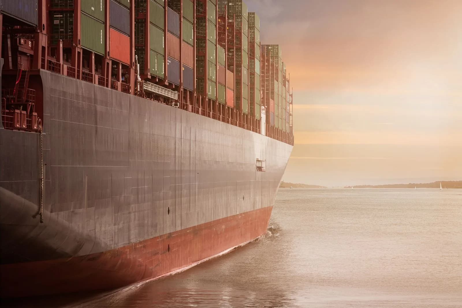 Container cargo ship at sunset, representing K.H. Infinity global trade operations