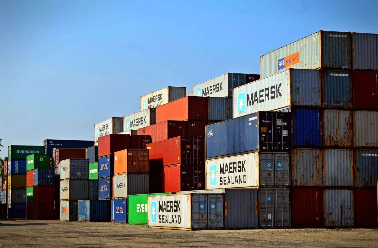 Colourful shipping containers stacked at a port, representing bulk import logistics